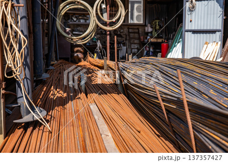 Rusty rebar and metal rods piled, showing construction materials at a metal workshop 137357427