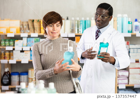 Woman choosing mouthwash with help from pharmacist 137357447