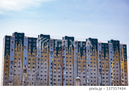 Modern residential tower building with abstract facade design under blue sky in Zelenograd Modern residential tower building with abstract facade design under blue sky in Zelenograd 137357484