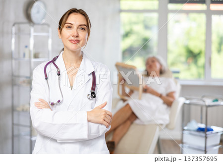 Portrait of young female doctor in scrub. Portrait of young female doctor in scrub. 137357695