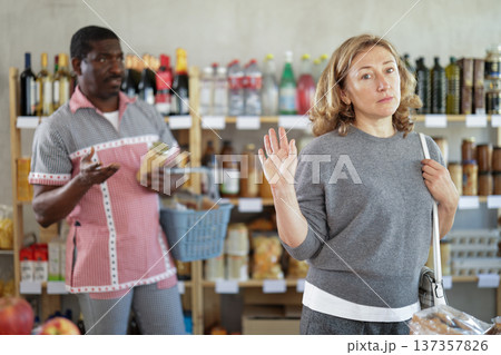 Family quarrel between husband and wife while shopping in grocery supermarket Family quarrel between husband and wife while shopping in grocery supermarket 137357826