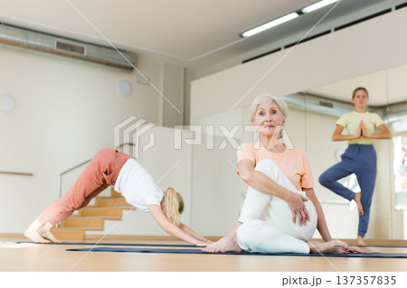 Senior woman practicing yoga in studio Senior woman practicing yoga in studio 137357835