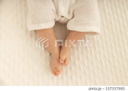 Soft baby feet resting peacefully on a cozy blanket 137357993