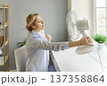 Sweating Woman Using Fan During Hot Weather 137358864