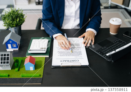 balancing the property sector The real estate agent is explaining the house style to see the house design balancing the property sector The real estate agent is explaining the house style to see the house design 137358911