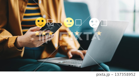 Customer service evaluation concept. Businesswoman pressing face smile emoticon show on virtual screen at tablet and smartphone Customer service evaluation concept. Businesswoman pressing face smile emoticon show on virtual screen at tablet and smartphone 137358952