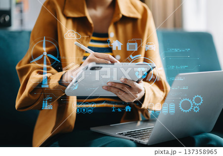 Businesswoman working virtual tablet computer twith reduce CO2 concept with icons, global warming such as reforest green factory recycle Businesswoman working virtual tablet computer twith reduce CO2 concept with icons, global warming such as reforest green factory recycle 137358965