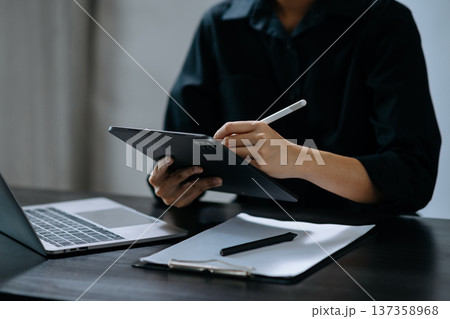 Businessman hand using smart phone laptop and tablet with social network diagram on desk 137358968