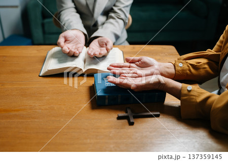 Two people reading and study bible in home and pray together.Studying the Word Of God 137359145