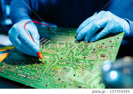 Close up of technician soldering and repairing circuit board in a modern laboratory, electronics repair, engineering, technology, maintenance and quality control concept. Close up of technician soldering and repairing circuit board in a modern laboratory, electronics repair, engineering, technology, maintenance and quality control concept. 137359393