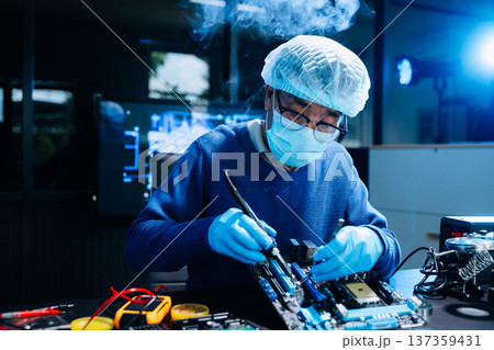 Professional electronics technician repairing computer motherboard in modern lab. Hardware engineering, cybersecurity, data technology, server maintenance 137359431