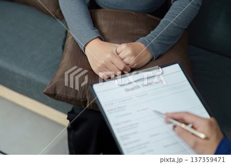 Mental Health Consultation. A healthcare professional discussing treatment options with a patient. Mental Health Consultation. A healthcare professional discussing treatment options with a patient. 137359471