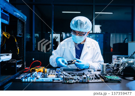 Professional electronics technician repairing computer motherboard in modern lab. Hardware engineering, cybersecurity, data technology, server maintenance 137359477