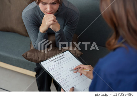 Mental Health Awareness. Woman expresses anxiety during a health summary review. Mental Health Awareness. Woman expresses anxiety during a health summary review. 137359480
