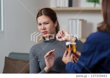 Patient Consultation. A healthcare professional discussing medication options with a hesitant patient. 137359481