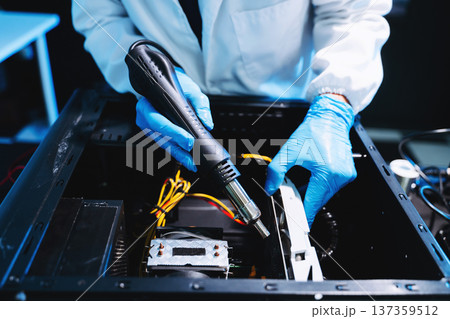 Technician installing graphics card inside desktop PC. Computer hardware upgrade, motherboard wiring, IT repair service and technology Technician installing graphics card inside desktop PC. Computer hardware upgrade, motherboard wiring, IT repair service and technology 137359512
