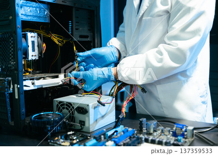 Professional technician repairing hard drive for data recovery in modern technology lab. Digital storage, cybersecurity, hardware repair and data protection concept. Professional technician repairing hard drive for data recovery in modern technology lab. Digital storage, cybersecurity, hardware repair and data protection concept. 137359533