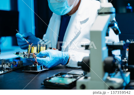 IT engineer repairing computer server hardware in laboratory. Electronics diagnostics, motherboard maintenance, cybersecurity infrastructure and data center 137359542