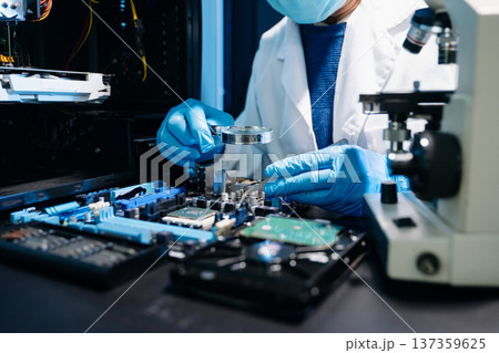 Closeup of expert soldering a green PCB board using precision tools. Ideal for electronics, circuit repair, engineering, tech Closeup of expert soldering a green PCB board using precision tools. Ideal for electronics, circuit repair, engineering, tech 137359625