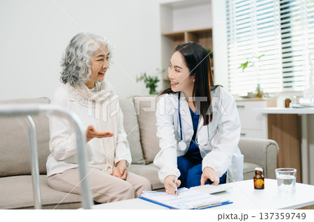 Doctor assisting elderly patient with medication, paperwork and healthcare planning at home, highlighting consultation, insurance, treatment and senior support. Doctor assisting elderly patient with medication, paperwork and healthcare planning at home, highlighting consultation, insurance, treatment and senior support. 137359749