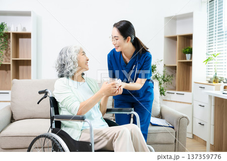 Female doctor explaining ear anatomy to elderly woman during home medical consultation. Hearing care, senior health, audiology, prevention, wellness and healthcare 137359776