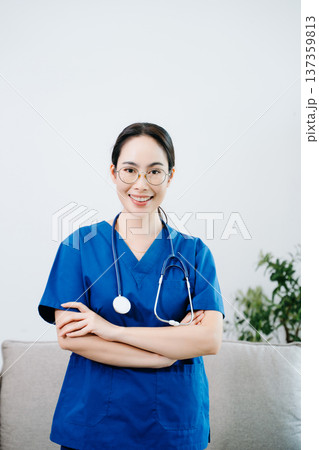 Confident Asian nurse in blue scrubs with stethoscope. Professional healthcare worker portrait for hospital, clinic, medical service, wellness Confident Asian nurse in blue scrubs with stethoscope. Professional healthcare worker portrait for hospital, clinic, medical service, wellness 137359813