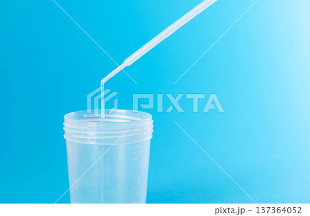 Prostate fluid collection for analysis against a blue background. Bacteriological culture for pathogenic bacteria in the prostate. Copy space for text Prostate fluid collection for analysis against a blue background. Bacteriological culture for pathogenic bacteria in the prostate. Copy space for text 137364052