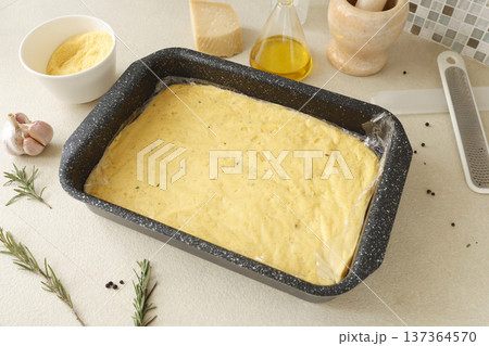 Hard polenta in rectangular metal dish on table. Cornmeal food in kitchen. Ingredients and traditional Italian cuisine. Hard polenta in rectangular metal dish on table. Cornmeal food in kitchen. Ingredients and traditional Italian cuisine. 137364570