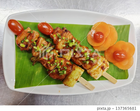 Grilled Chicken Yakitori Skewers with Teriyaki Glaze and Vegetable Garnish Grilled Chicken Yakitori Skewers with Teriyaki Glaze and Vegetable Garnish 137365681