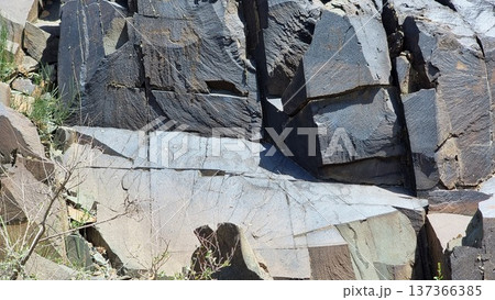 Stone wall in the spring. Stones with petroglyphs. Stone wall in the spring. Stones with petroglyphs. 137366385