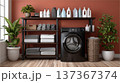 Modern Laundry Room Setup with Black Washing Machine, Organized Shelving, and Plants Against a Warm  137367374