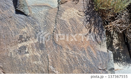 Stones with petroglyphs. Stone background texture. Stones with petroglyphs. Stone background texture. 137367555