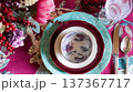 Elegant table setting with colorful dinnerware, floral patterns, and festive decorations for special dining experience 137367717
