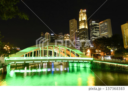 Night view of the Elgin Bridge in Civic District, Singapore, a vehicular box-girder bridge across the Singapore River, with a background of Financial District skyscrapers. Night view of the Elgin Bridge in Civic District, Singapore, a vehicular box-girder bridge across the Singapore River, with a background of Financial District skyscrapers. 137368383