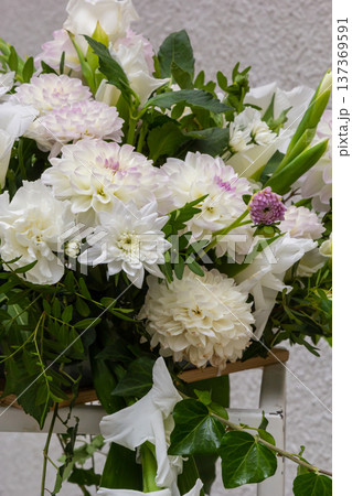 Beautiful white floral arrangement with greenery in a decorative display 137369591