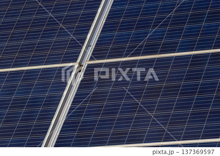 Solar panels capture sunlight for renewable energy in a modern installation Solar panels capture sunlight for renewable energy in a modern installation 137369597