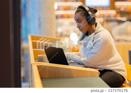 Focused student studying at library 137370176
