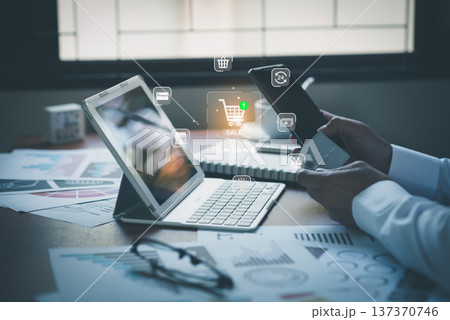 Close up of businessman hands holding smartphone and credit card with virtual e-commerce and online shopping cart overlay Close up of businessman hands holding smartphone and credit card with virtual e-commerce and online shopping cart overlay 137370746