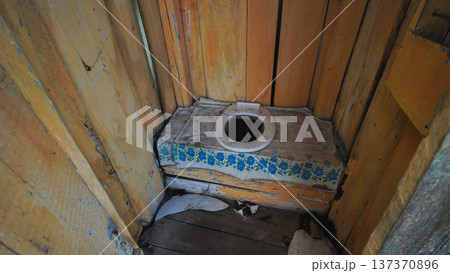 Old wooden toilet in a slavic village standing in the backyard Old wooden toilet in a slavic village standing in the backyard 137370896
