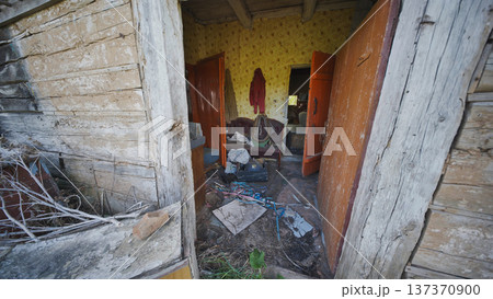 Abandoned old wooden house interior showing decay and neglected belongings Abandoned old wooden house interior showing decay and neglected belongings 137370900