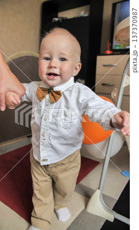 Little baby boy learning first steps with parent guidance and happy smile 137370987