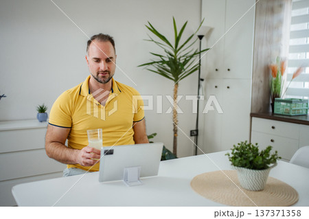 Man learning working from home using digital tablet Man learning working from home using digital tablet 137371358