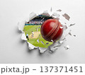 Red cricket ball bursting through a white paper hole with stadium background. 137371451
