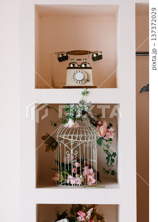 Vintage Decor Shelf with Retro Phone and Flower Birdcage Vintage Decor Shelf with Retro Phone and Flower Birdcage 137372029