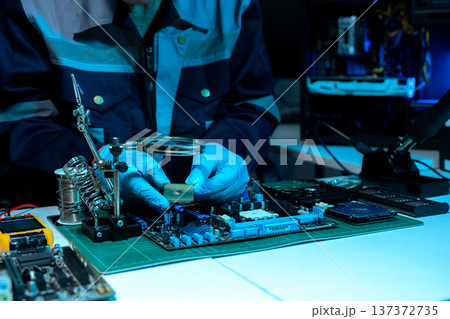 Macro photo of a finger touching a laptop chip close up 137372735