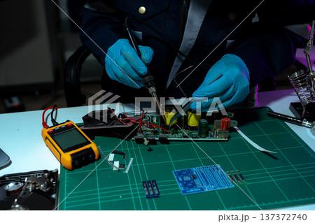 Close up of Technician measuring voltage electronic circuit board, Service after sale fix electric equipment. Close up of Technician measuring voltage electronic circuit board, Service after sale fix electric equipment. 137372740