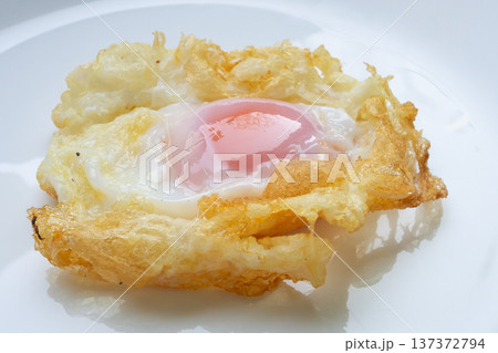Fried egg on white dish close up 137372794