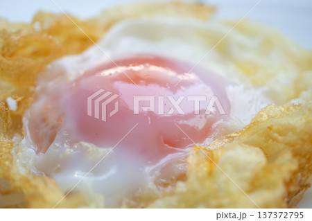 Fried egg on white dish close up 137372795