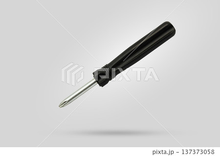 screwdriver fly over gray background close up screwdriver fly over gray background close up 137373058