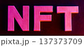 Bold pink NFT letters with neon glow effect on dark background for crypto art concept 137373709